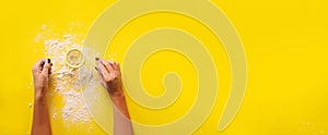 Female hand holding sieve flour on yellow background. Baking and cooking concept. Banner with copy space