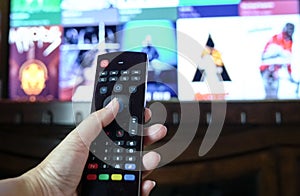 Female hand holding a smart tv remote control