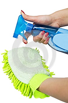 Female hand holding spray bottle and duster