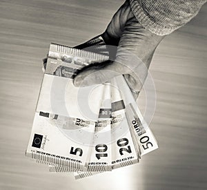 Female hand holding stacks of Euro Bills