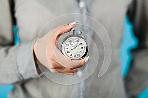 Female hand holding a stopwatch