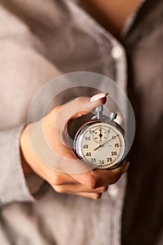 Female hand holding a stopwatch