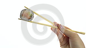 Female hand holding sushi with chopsticks isolated on white background. Close-up.