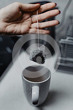 Female hand holding a tea bag