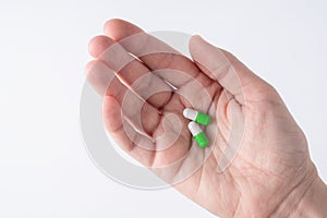 Female hand holding two pills