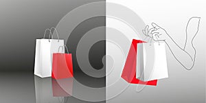 Female hand holding two shopping bags. Two gift packages red and white in painted hand of young woman. Packing bags with