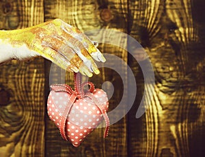 Female hand holding valentine heart