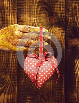 Female hand holding valentine heart