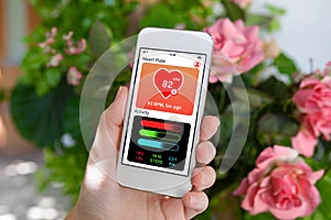 female hand holding white phone app health tracking activity screen