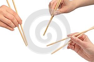 Female hand holding wooden sushi chopsticks isolated on white background