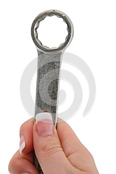 Female hand holding wrench tool photo