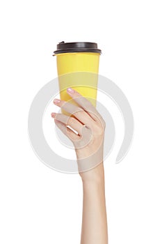 Female hand holding yellow glass on white background