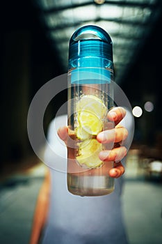 Female hand holds a bottle with detox drink
