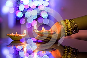 Female hand holds diwali lamp