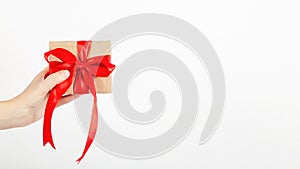 Female hand holds a gift box on a white background. Holiday and shopping concept. Christmas, Valentine`s Day, Mother`s Day, Wome