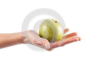 Female hand holds a green apple