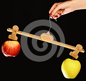 Female hand holds hanger with fruits on tips