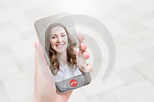 female hand holds a mobile phone in hand and talking to her girlfriend on video chat, video calls, conference