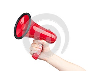 Female hand holds a red megaphone, isolated on white background. File contains a path to isolation.