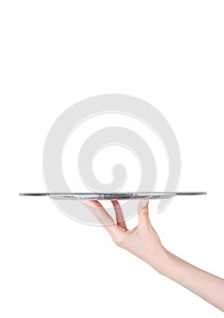Female hand holds stainless steel catering tray photo