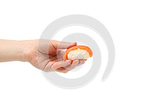 Female hand holds sushi roll, isolated on background