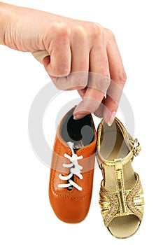 Female hand holds tiny dancing shoes