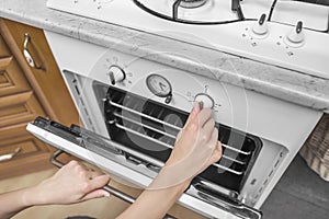 Female hand includes oven.