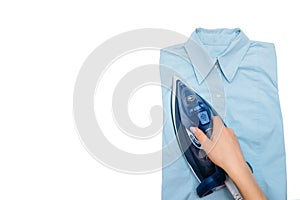 Female hand ironing clothes top view isolated on white background. Young woman with iron ironing mans shirt seen