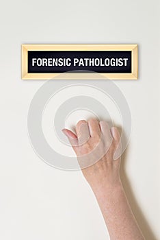 Female hand is knocking on Forensic Pathologist door