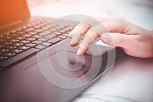 female hand on a laptop, touchpad. work at the computer. notebooks