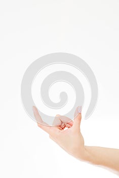 Female hand measuring invisible items, woman`s palm making gesture while showing small amount of something on white isolated