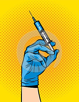 A female hand in a medical glove holds a syringe.