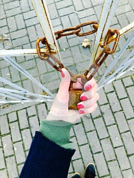 Female hand with a metal chain, fear of losing freedom. Quarantine characters. Insulation.