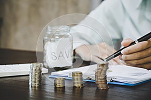 Female hand with money coin stack