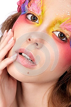 Female with hand near face and fashion feather eyelashes make-up