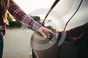 Female hand open car door, driver beginner concept
