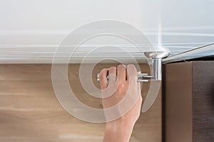 female hand open the door. Top view of woman arm holds door handle