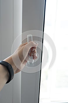 Female hand open plastic pvc white window, close-up