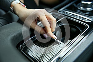 Female hand opens the Cup holder in the car