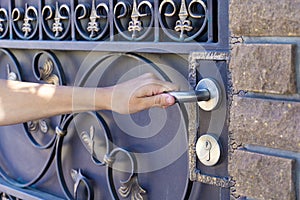 A female hand opens the front street door