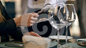 Female hand paying by bank card in restaurant. Contactless payment