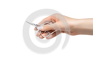 Female hand with perfect manicure holds nail scissors. Manicure scissors isolated on a white background