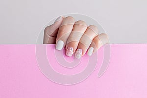 Female hand with pink and white manicure nails