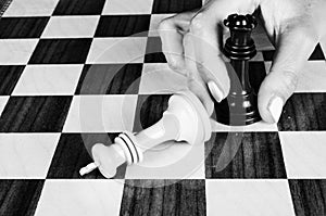 Female hand playing chess