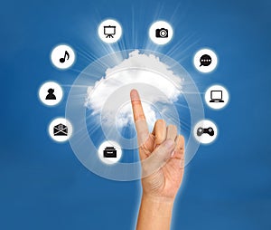 Female hand point on cloud with icon against blue sky