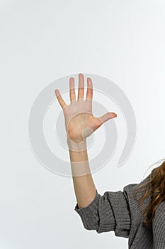 Female hand pointing up with finger number five