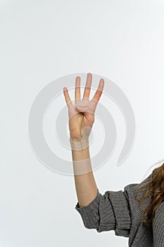 Female hand pointing up with finger number four