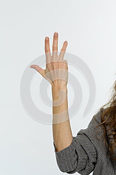 Female hand pointing up with finger number four