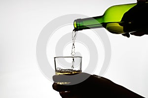 Female hand pouring wine into glass