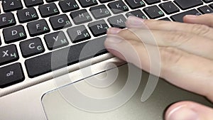 Female hand presses the spacebar button on the laptop keyboard.